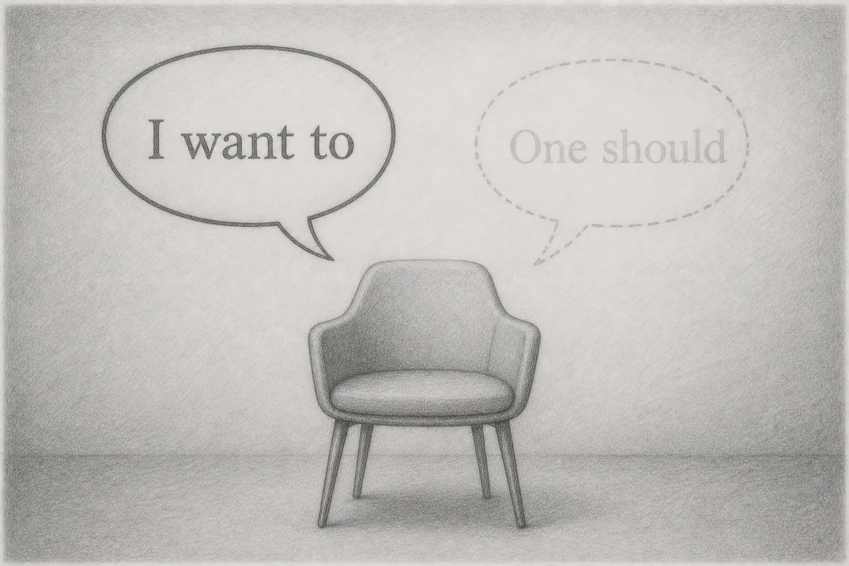 Pencil drawing: An empty armchair sits in a room, above it two speech bubbles, a solid one on the left reading “I want to”, a dashed, faded one on the right reading “One should”, a symbol of how the shift from “I” to “one” lets personal agency fade.